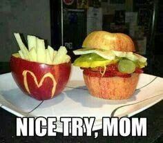 an apple with a hamburger and french fries in it