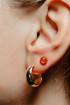 A perfect Autumn earring! Shimmering with orange fire this antique revival single stud is handmade and is designed by our goldsmiths. Made of solid 10k yellow gold, this beautiful oriental style gold earring is set with carnelian cabochons. The carnelian has a lovely shimmer and measures 0.2 inch in diameter. It sits in figural elongated claws and reflects the light beautifully when worn! Will look lovely mixed and matched with your antique and artisan earrings! Can be bought as a pair or a sing Cheap Orange Pierced Earrings, Gold Carnelian Gemstone Earrings, Gold Carnelian Jewelry With Matching Earrings, Orange Carnelian Gemstone Earrings, Carnelian Gemstone Round Earrings, Round Carnelian Gemstone Earrings, Round Orange Carnelian Earrings, Orange Carnelian Round Earrings, Orange Carnelian Earrings