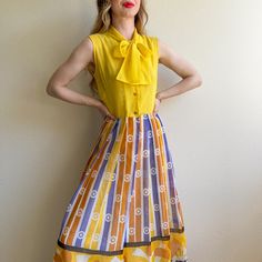 A Bright And Cheerful 70s Maxi Dress! Buttons Up The Front. Interior Skirt Button. Top Is Not Lined. Skirt Is Lined In A Soft White Fabric Underlay. Skirt's Novelty Print Features A Floral Pattern In Yellow, Orange, Purple, And Black Colors. Abstract Pattern Design. Please Note: There Are Small Faint Marks On The Left Tie, But Overall Does Not Affect The Wearability Of The Garment. Please Check Photos Provided. No Label. No Stretch. Fabric Content Is Cotton. Dress Is In Excellent Condition. Freshly Cleaned And Ready To Wear! Measurements Bust: 36 Inches Waist: 28 Inches Hips: 38 Inches Length: 57 Inches Shoulder: 15 Inches Would Best Fit A Small Up To A Medium. Model's Measurements Bust: Yellow A-line Vintage Dress For Summer, Yellow Vintage Fashion Dress, Spring Yellow A-line Vintage Dress, Yellow Vintage Dress For Summer Daywear, Yellow Vintage Summer Dress For Daywear, Yellow Retro Dress For Vintage Fashion, Retro Yellow Dress For Vintage Fashion, Yellow Dresses With Retro Print For Summer, Yellow Retro Print Summer Dress