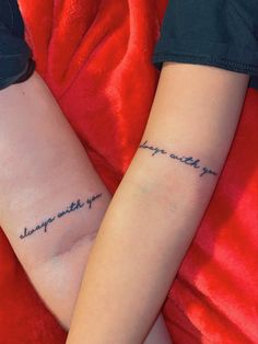 two people with tattoos on their arms that say, i can't wait for you