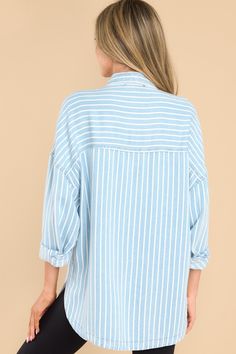 Looking for an effortless classic? This Always Lovely Blue Striped Top is your go-to for effortless, casual style. Throw it on and get ready for the compliments! This top features a collared neckline, functional buttons down the front, two functional bust pockets, long sleeves with buttoned cuffs, a scoop bottom hem, and a super soft material. Model is wearing a small. • 100% Lyocell • Hand Wash Cold • Unlined • Imported Oversized Light Blue Collared Top, Oversized Collared Light Blue Top, Blue Tops With Shirttail Hem And Button Closure, Light Wash Collared Tops For Day Out, Casual Blue Top With Collared Neckline, Casual Blue Tops With Collared Neckline, Light Wash Oversized Collared Top, Oversized Light Blue Tops For Day Out, Oversized Light Blue Top For Day Out