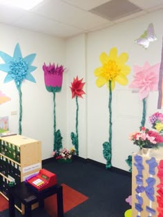 an office decorated with paper flowers and decorations