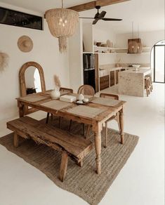 a wooden table sitting on top of a rug next to a white kitchen countertop