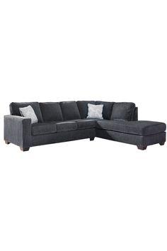 a gray sectional couch with pillows on it's back and the seat facing outward