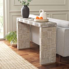 a white couch sitting next to a table on top of a hard wood floor