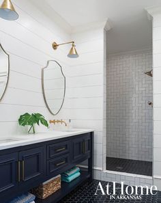 a bathroom with two sinks and mirrors on the wall