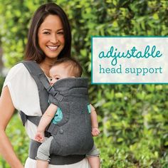 a woman is holding a baby in a grey sling that says, adjustable head support