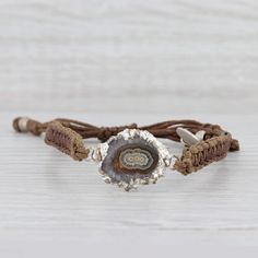 This lovely new bracelet is an authentic Nina Nguyen piece. This bracelet has a retail price of $195. Gem: Marbled Brown Geode Quartz Metal: Silver Toned Weight: 5.6 Grams  Stamps: Nina Nguyen Style: Brown woven chord with center charm Closure: Adjustable Drawstring Inner Circumference: 6"- 9 1/2" Width: 6.5 mm Charm: 16.7 x 26 mm Each piece is thoroughly examined and refinished as needed by our professional jewelers, graded by our in-house GIA (Gemological Institute of America) Graduate Gemolog Adjustable Artisan Sterling Silver Beaded Bracelets, Artisan Adjustable Bangle Bracelets, Adjustable Silver Chain Bracelet, Spiritual Style, Adjustable Silver Chain Bracelet With Spiritual Style, Adjustable Bohemian Sterling Silver Chain Bracelet, Adjustable Silver Spiritual Chain Bracelet, Bohemian Silver Bracelets With Sliding Knot, Adjustable Silver Jubilee Bracelet, Adjustable Bohemian Sterling Silver Bracelet Gift