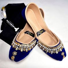 The Anayas Collection Pakistani/Indian Fancy Khussa, or wedding shoes, are a traditional and ornate type of footwear commonly worn in Pakistan and India, especially during special occasions like weddings. Here is a detailed description of these shoes: Design and Embellishments: These Khussa shoes are intricately designed with meticulous attention to detail. They typically feature elaborate embroidery, beadwork, sequins, and other decorative elements. The embroidery often follows traditional patterns and motifs, reflecting the rich cultural heritage of the region. Materials: These shoes are crafted from high-quality materials to ensure both comfort and durability. The upper part is usually made of fine fabrics like silk, satin, or velvet, which provide a luxurious feel. The sole is traditio Traditional Wedding Heels With Handwork, Elegant Flats With Round Toe For Reception, Elegant Round Toe Flats For Reception, Festive Wedding Heels With Round Toe, Elegant Handwork Wedding Shoes For Formal Occasions, Traditional Wedding Heels With Round Toe, Elegant Festive Flats With Round Toe, Traditional Festive Wedding Heels, Traditional Wedding Heels For Festive Occasions