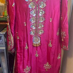 Silk, Pink, South Asian, 3 Piece Outfit, Hand Embroidered Dress. This One Of A Kind Outfit Comes A Silk Kameez Embroidered With Gold Thread Work And Beading, A Gold Dupatta With Gold Beading, And Matching Silk, Pink, Elastic, Trouser Pants That Allows For Multiple Sizing Options. The Bust Size Is 36-37 Inches, Sleeves Are 20-21 Inches, Waist Is 30-32 Inches And The Pant Length Will Fit Anyone Who Is 5’2-5’6”. The Sleeves Have The Same Intricate Design As The Bust. Carefully Steam Or Iron. All Thread Work Is Lined And Overlocked. This Outfit Is Made In India By Skilled Artisans! Note: Any Defects Not Mentioned But Visible In The Pictures Will Be Considered As Described. All Items Have Embellished Pink Silk Traditional Wear, Pink Embellished Silk Traditional Wear, Pink Silk Embellished Sets, Embellished Pink Silk Sets, Pink Embellished Silk Sets, Pink Silk Traditional Wear For Formal Occasions, Elegant Pink Dress With Zari Work, Formal Pink Silk Traditional Wear, Pink Silk Dress With Dabka Work