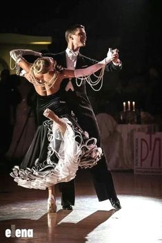 a man and woman dancing on a dance floor