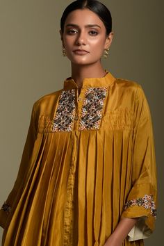 Mustard three quarter sleeve high low kurta, elevated with pearl embellished yoke. Paired with ivory dhoti pant.
Component: 2
Pattern: Embellished
Type Of Work: Sequins
Neckline: Stand Collared Neck
Sleeve Type: Three Quarter Sleeves
Fabric: Kurta: Organza, Dhoti: Satin 
Color: Yellow
Other Details: 
Sequin embellished cuffs
Concealed placket
Occasion: Mehendi and Haldi - Aza Fashions High Low Kurta, Asymmetric Kurta, Dhoti Pants, Two Sisters, Satin Color, Three Quarter Sleeves, Aza Fashion, Fashion Set, Stand Collar