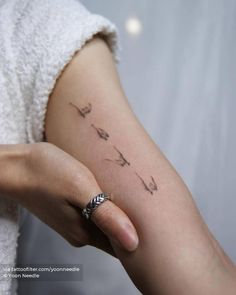 a woman's arm with a small tattoo on the left side of her arm