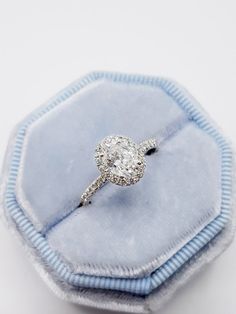 an engagement ring in a blue velvet box