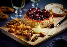 a wooden cutting board topped with bread and jelly