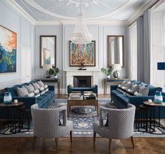 a living room filled with blue couches and chairs