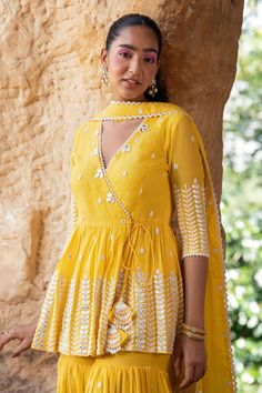 Buy Yellow Peplum Top Cotton Mulmul Leaf Angrakha Sharara Set For Women by PREEVIN Online at Aza Fashions. Festive Anarkali Kurta With Peplum Style, Anarkali Peplum Kurta For Festive Occasions, Designer Eid Anarkali Set With Peplum Shape, Designer Peplum Anarkali Set For Navratri, Anarkali Peplum Kurta For Festivals, Anarkali Salwar Kameez With Peplum For Eid, Navratri Designer Anarkali Set With Peplum Shape, Eid Anarkali Salwar Kameez With Peplum, Traditional Peplum Palazzo Set For Festivals