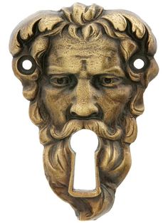 an old fashioned door handle with a face and key hole in the shape of a man's head