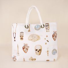 a white handbag with various medical items on the front and side, all over it