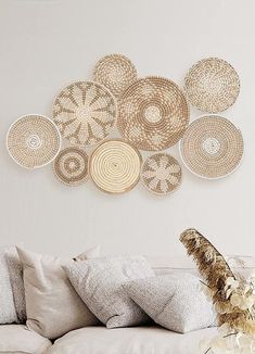 a living room filled with lots of furniture and decor on top of a white wall