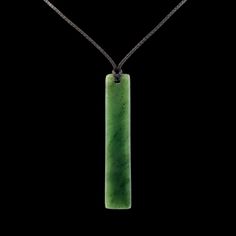 a green rectangular pendant on a black background