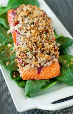 a white plate topped with salmon and spinach