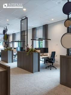 an office with several planters in the middle of it's cubicle area