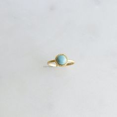 18k Gold Dipped Round Turquoise Stone Ring. This adjustable ring features a stunning round turquoise stone surrounded by tiny bead texture, this minty blue turquoise is known for its vibrant color and symbolic significance of protection and positive energy. The ring is carefully dipped in 18k gold, adding a touch of luxury and sophistication. Its adjustable size ensures a comfortable fit for any finger, making it a versatile accessory for all occasions. ◼️ MEASURES One Size, Size 6 Closed - Adjustable Size ◼️ CARE: * Avoid contact with chemicals, sweat, salts, and oils. Your jewelry will last a long time if you care for it properly. ◼ PLEASE NOTE: Business days do not include weekends & holidays, as the postal service does not operate on these days. *All photographs are photographed by me Turquoise Round Spiritual Jewelry, Handmade Minimalist Turquoise Round Ring, Unique Turquoise Round Gemstones, Turquoise Round Gold-plated Jewelry, Turquoise Stone Ring, Beaded Frame, Luxury Yellow Gold Turquoise Ring, Oval Cabochon, Bead Frame, Aesthetic Minimalist