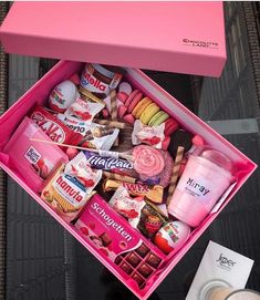 a pink box filled with lots of different types of candies