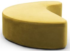 a large yellow ottoman sitting on top of a white floor