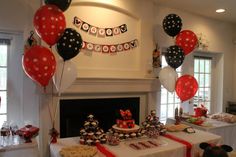 a birthday party with balloons, cake and decorations