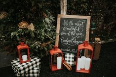 a chalkboard sign sitting on top of a black and white checkered table cloth