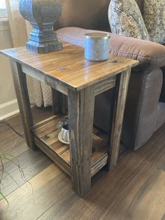 a wooden table sitting on top of a hard wood floor next to a couch and chair