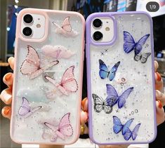 two women holding up their phone cases with butterflies on them