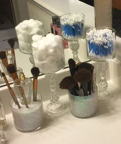 there are many different types of makeup brushes in the cup on the bathroom sink counter