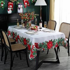 a dining room table decorated for christmas with stockings and poinsettis