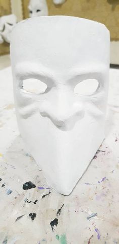 a white mask sitting on top of a table