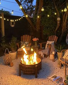 a fire pit surrounded by chairs and lights