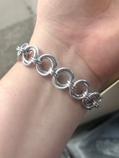 SIMPLE MOBIUS CHAINMAILLE BRACELETS - $15.00 each Materials: Anodized Aluminum Rings & Stainless Steel Lobster Clasps Chain Weave: Mobius Weave (2-Ring Variation) **Default sizing for bracelets come in 6-, 7-, 8-, and 9-inch wrist sizes.  If you need something smaller or bigger, please reach out with your wrist measurement for custom sizing at no additional cost.** Feel free to reach out for special requests and custom orders.   ABOUT THE SHOP:   Silver Rose Chainmaille is based out of Kansas an Metal Bracelets With Jump Ring For Jewelry Making, Adjustable Stainless Steel Bracelet With Jump Ring, Stainless Steel Round Bracelets For Jewelry Making, Hypoallergenic Metal Bracelets For Jewelry Making, Stainless Steel Jewelry Making Jump Rings, Nickel-free Stainless Steel Bracelets For Jewelry Making, Silver Chain Bracelet With Jump Ring, Chainmaille Ring, Chainmaille Jewelry Patterns