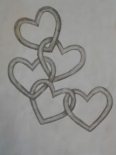 two hearts are intertwined in the shape of a knot on a piece of paper