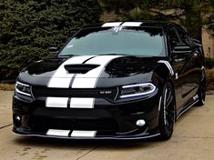 a black and white car parked in front of a house