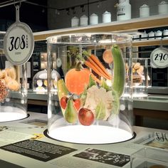 the display case is filled with many different fruits and vegetables