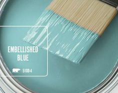 a paint can with a brush in it and the words, embellished blue