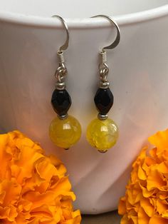 Handmade yellow and black glass bead earrings Amber Beaded Drop Earrings, Round Black Beaded Earrings For Gifts, Round Black Beaded Earrings As Gift, Round Earrings With Black Beads For Gift, Black Czech Glass Jewelry With Ear Wire, Black Faceted Bead Earrings For Gift, Black Faceted Beads Earrings For Gift, Handmade Yellow Beaded Earrings With Czech Glass, Yellow Beaded Earrings With Czech Glass