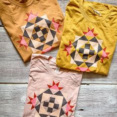 three t - shirts with geometric designs on them