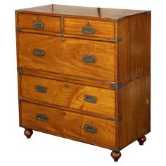 an old wooden dresser with three drawers and two metal pulls on the bottom, against a white background