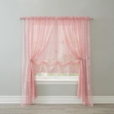 a pink curtain hanging in front of a window