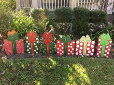 a group of wooden christmas presents sitting in the grass