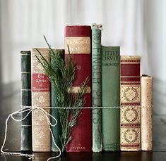 there are many books on the table and one is tied up with a twine