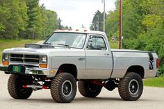 a gray truck parked on the side of a road